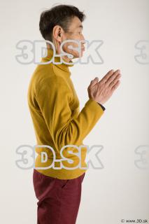 Arm flexing reference of yellow sweater red trousers Sidney 0014